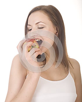 Young pretty brunette girl eating red apple isolated on white