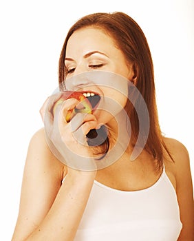 Young pretty brunette girl eating red apple isolated on white