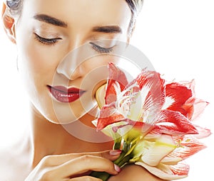 Young pretty brunette real woman with red flower amaryllis close