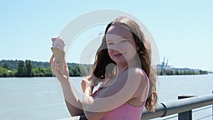 Young Pretty Brunette Woman eating an Ice Cream Cone on a Summer Street, Slow motion