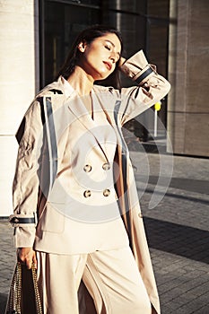 Young pretty brunette woman in fashion suit at buseness building posing cheerful, lifestyle people concept