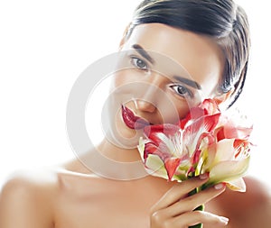 Young pretty brunette woman with red flower amaryllis close up isolated on white background. Fancy fashion makeup