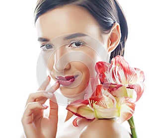 Young pretty brunette woman with red flower amaryllis close up isolated on white background. Fancy fashion makeup