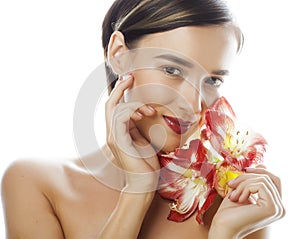 Young pretty brunette woman with red flower amaryllis close up isolated on white background. Fancy fashion makeup