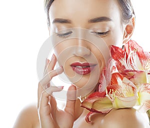 Young pretty brunette woman with red flower amaryllis close up isolated on white background. Fancy fashion makeup