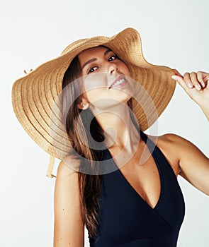 Young pretty brunette woman wearing summer hat and swimsuit isolated on white background preparing to vacations