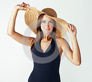 Young pretty brunette woman wearing summer hat and swimsuit isolated on white background preparing to vacations