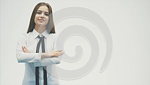 Young pretty business girl standing on a white background. During this draws straight hand, looking up into the camera