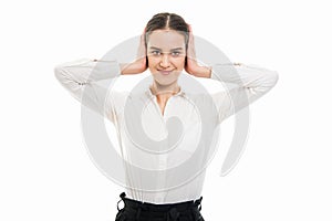 Young pretty business woman covering ears like deaf gesture
