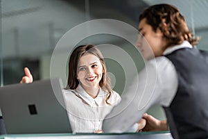 Young pretty business woman and handsome man have meeting in the office