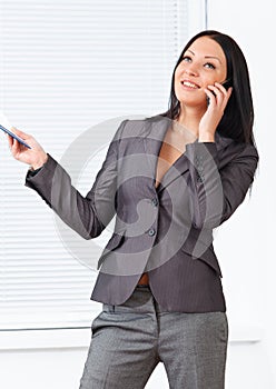 Young pretty business woman with notebook in the office