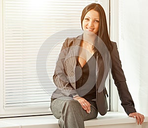 Young pretty business woman with notebook in the office