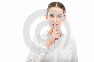 Young pretty business woman showing silence gesture