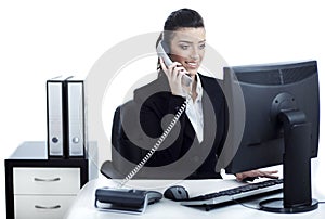 Young and pretty business woman talking over phone