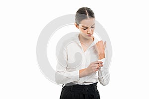 Young pretty bussines woman buttoning shirt sleeve gesture photo