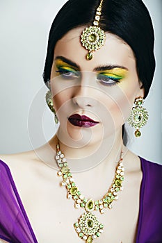 Young pretty caucasian woman like indian in ethnic jewelry close