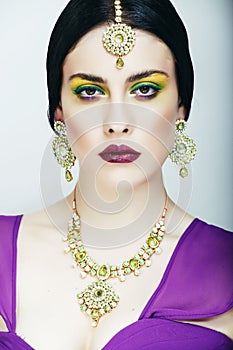 Young pretty caucasian woman like indian in ethnic jewelry close