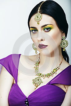 Young pretty caucasian woman like indian in ethnic jewelry close