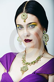 Young pretty caucasian woman like indian in ethnic jewelry close