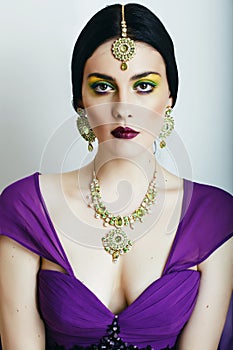 Young pretty caucasian woman like indian in ethnic jewelry close