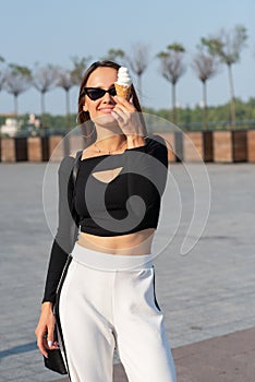 Young pretty cheerful woman eating ice cream