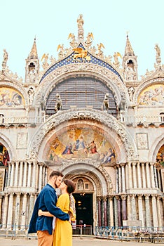 young pretty couple kissing in front of saint marks basilica venice italy