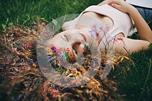 A Young Girl Laying At The Grass