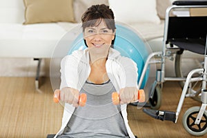 young pretty disable woman exercising at home