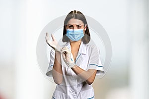 Young pretty doctor in medical mask.