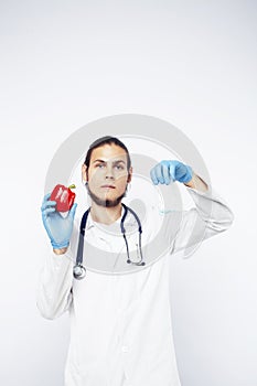 Young pretty doctor with stethoscope holding fruits, vegetables and pills, healthy food care concept