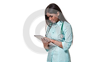 Young pretty doctor with a stethoscope and a medical history in her arms