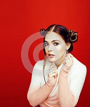 Young pretty emitonal posing teenage girl on bright red background, happy smiling lifestyle people concept