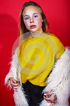 Young pretty emitonal posing teenage girl on bright red background, happy smiling lifestyle people concept