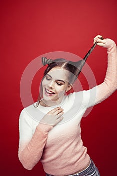 young pretty emitonal posing teenage girl on bright red background, happy smiling lifestyle people concept