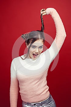 young pretty emitonal posing teenage girl on bright red background, happy smiling lifestyle people concept