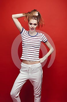 young pretty emitonal posing teenage girl on bright red background, happy smiling lifestyle people concept