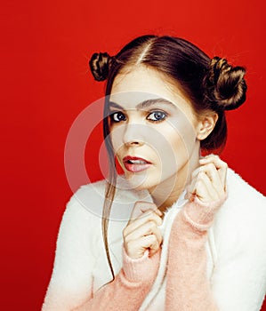 Young pretty emitonal posing teenage girl on bright red background, happy smiling lifestyle people concept