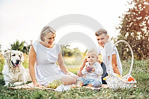 Young cute family on picnic with dog