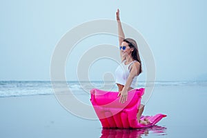 Young pretty fashion woman body posing in summer with mattress in black bikini and having fun