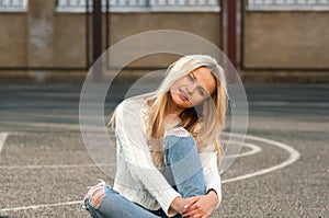 Young pretty fashionable blonde woman dressed in ripped jeans
