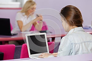 young pretty female college student with laptop