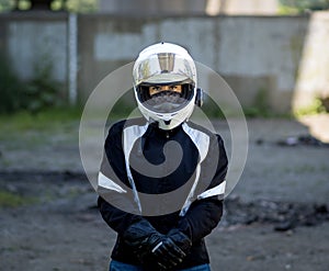 Young pretty female motorcyclist with full face helmet