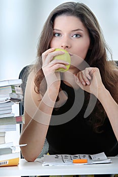 Young and pretty female student with books