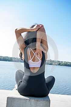 Young pretty fitness  woman doing yoga poses, streching in the nature. Healthy lifestyle