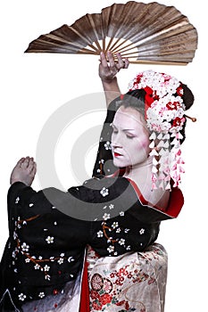 Young pretty geisha in kimono with sakura and decoration