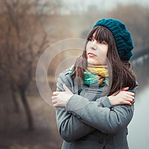 Young pretty girl in cold weather outdoors
