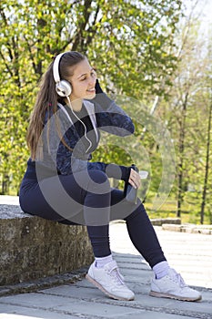 Young pretty girl doing exercise and running in the park