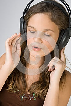 Young pretty girl listening music with headphones