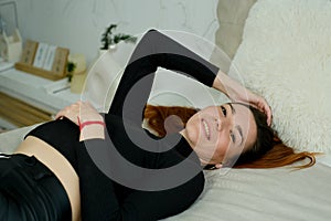 Young pretty girl with long red hair in a black shirt