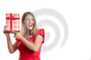 Young pretty girl in red dress holding presents. isolated